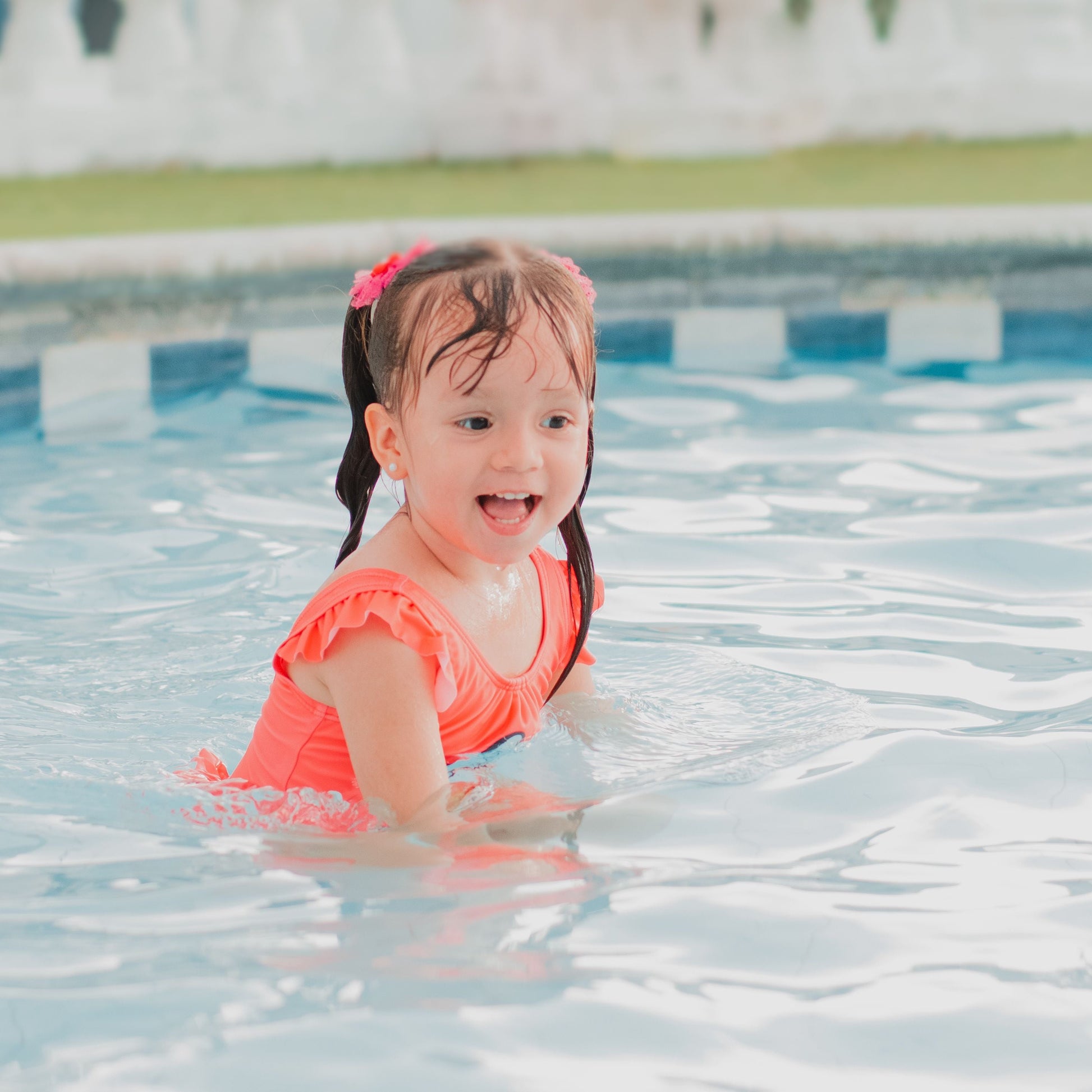 happy girl doing swimming lessons
