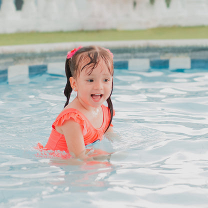happy girl doing swimming lessons